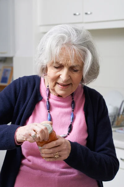 Seniorin müht sich, Deckel aus Glas zu nehmen — Stockfoto