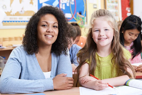 Portret van leraar met vrouwelijke basisschool leerling van klas — Stockfoto