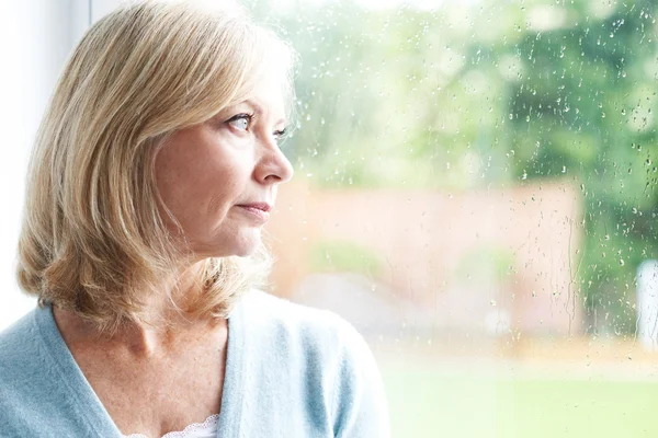 Sad Mature Woman Suffering From Agoraphobia Looking Out Of Windo — Stock Photo, Image