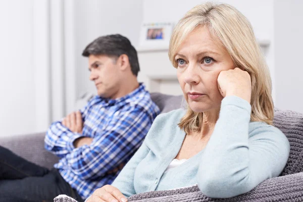 Mature Couple With Relationship Difficulties Sitting On Sofa