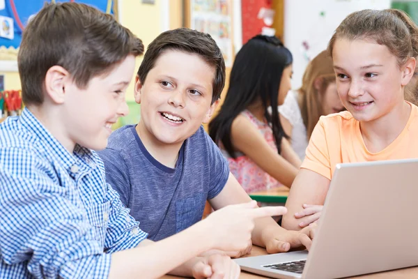 Grupo de crianças do ensino fundamental que trabalham juntas no computador — Fotografia de Stock