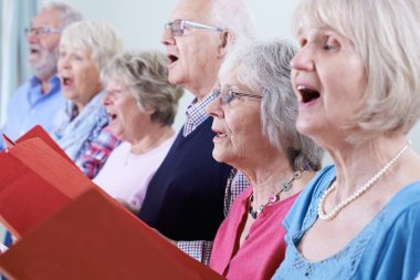 Group Of Seniors Singing In Choir Together clipart