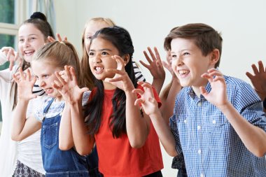 Group Of Children Enjoying Drama Club Together clipart