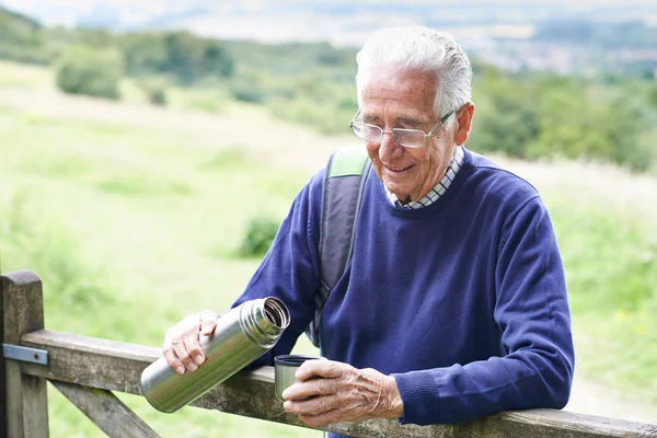 Senior Man Having Drink From Flask Whilst On Walk — Stock Photo, Image