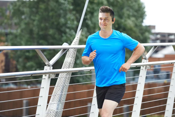 Young Man Running In Urban Setting Listening To Music — Stock Photo, Image