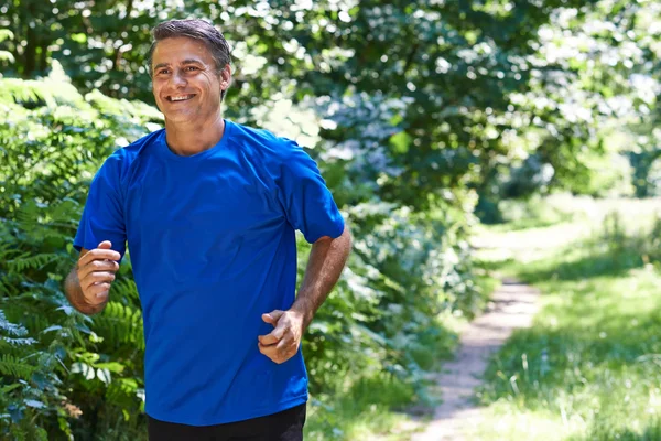 Mature Man Running Outdoors In Countryside — Stock Photo, Image