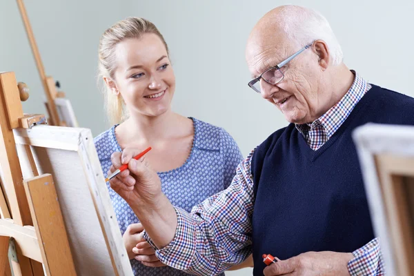 Senior Man Attending Painting Class With Teacher — Stock Photo, Image