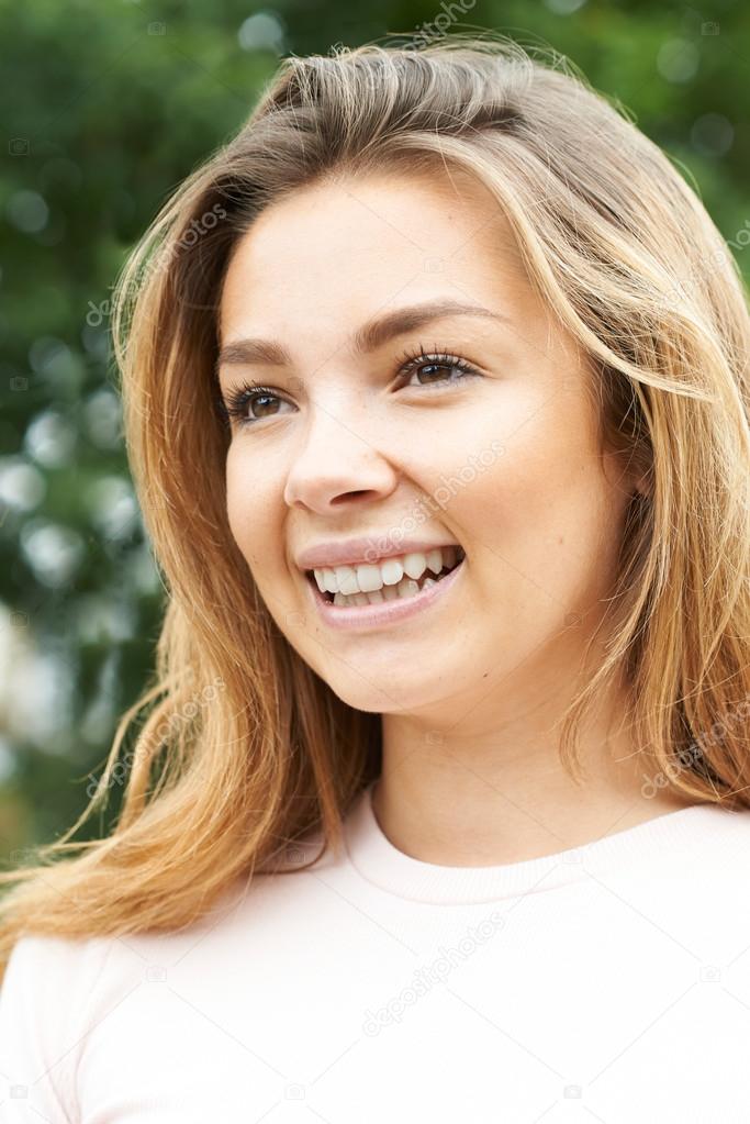 Head And Shoulders Portrait Of Smiling Teenage Girl