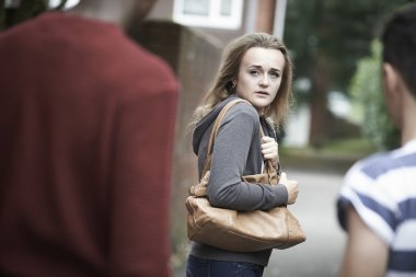 Teenage Girl Feeling Intimidated As She Walks Home clipart