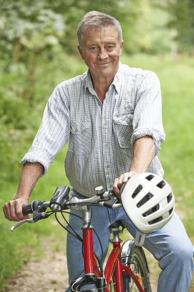 Senior Man Enjoying Cycle Ride In The Countryside — Stock Photo, Image