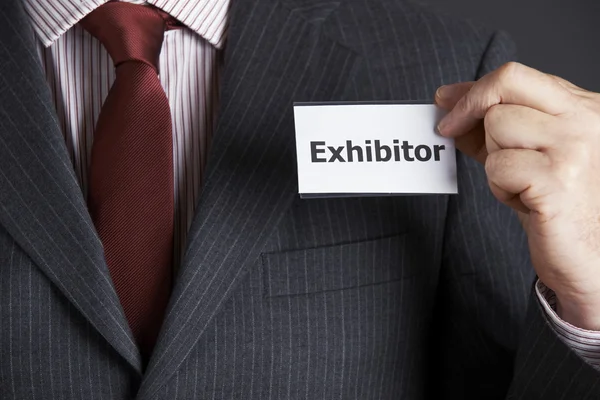 Businessman Attaching Exhibitor Badge To Jacket — Stok Foto