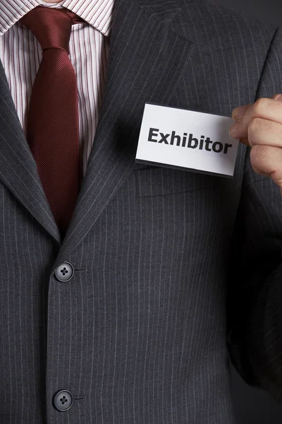 Businessman Attaching Exhibitor Badge To Jacket — Stok Foto