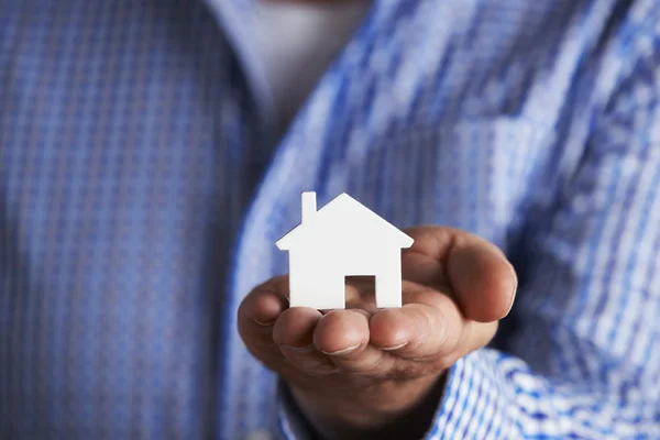 Man Holding Model House In Palm Of Hand — Stock Photo, Image