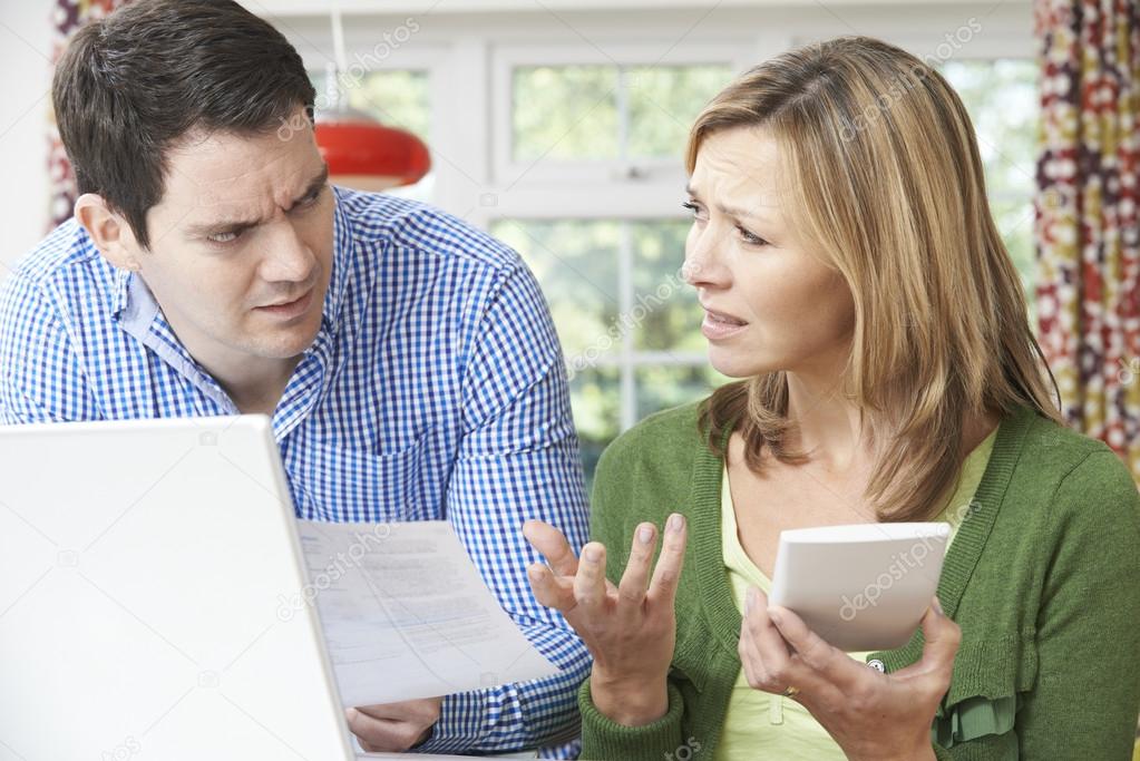 Worried Couple Discussing Domestic Finances At Home