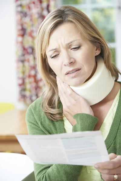 Mujer leyendo carta después de recibir lesión en el cuello —  Fotos de Stock