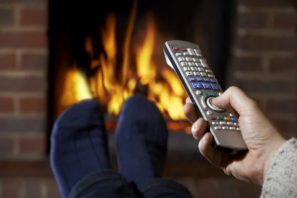 Man With Remote Control Watching Television And Relaxing By Fire — Stock Photo, Image