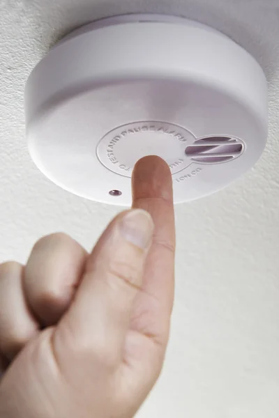 Close Up Of Hand Testing Domestic Smoke Alarm — Stock Photo, Image