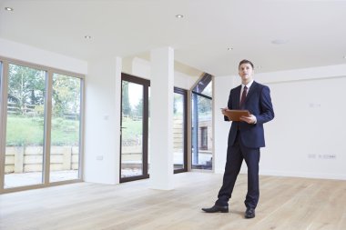 Estate Agent Looking Around Vacant Property For Valuation clipart