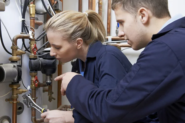 Female Trainee Plumber Working On Central Heating Boiler — Stock Photo, Image