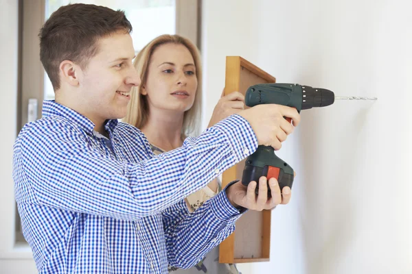 Couple Drilling Wall To Hang Picture Frame — Stock Photo, Image