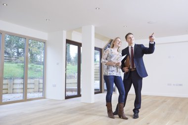 Estate Agent Showing Prospective Female Buyer Around Property clipart