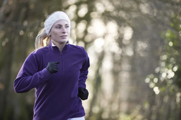 Woman On Winter Run Through Woodland — Stock Photo, Image