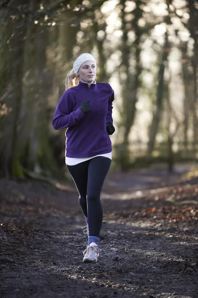 Woman On Winter Run Through Woodland — Stock Photo, Image