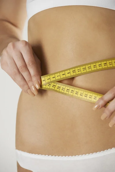 Close-Up Of Woman In Underwear Measuring Waist With Tape — Stock Photo, Image