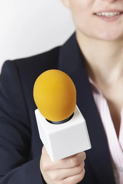 Tiro abstrato de jornalista feminino com microfone — Fotografia de Stock