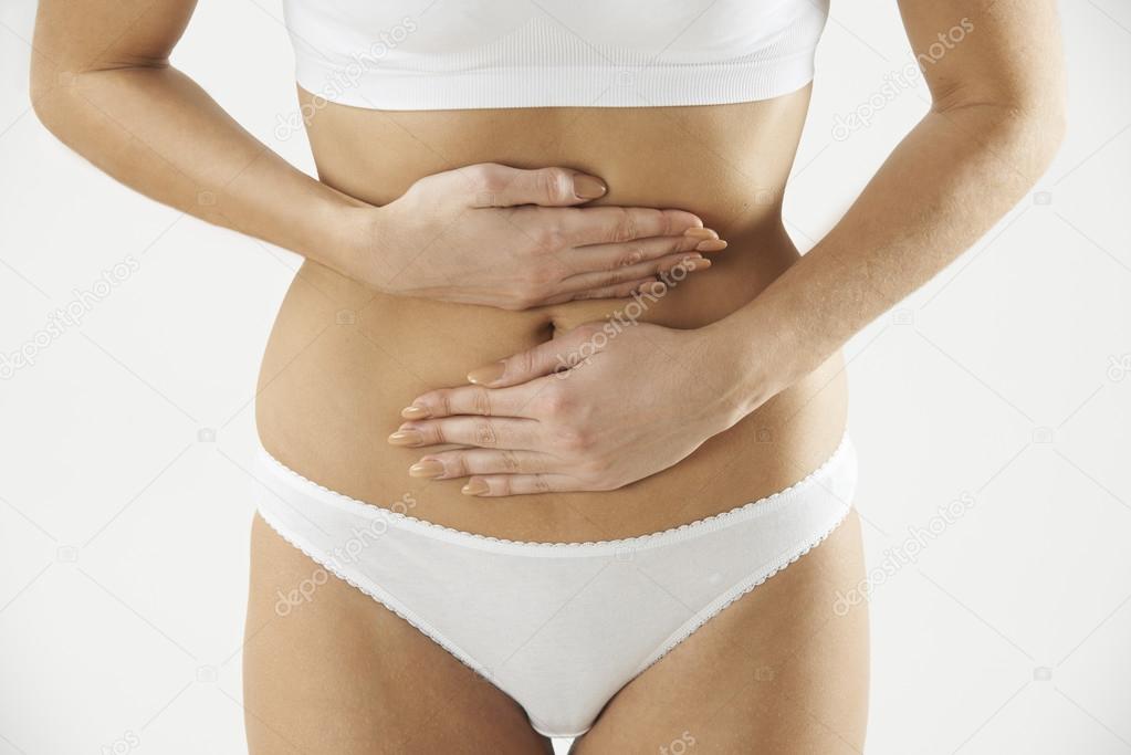 Close Up Of Woman In Underwear Holding Stomach In Pain Stock Photo