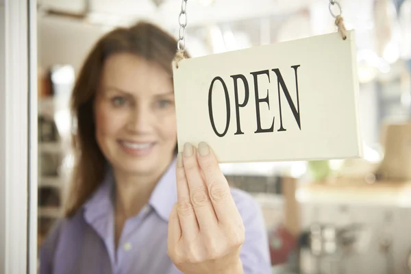 Store Owner Turning Open Sign In Shop Doorway — Stock Photo, Image