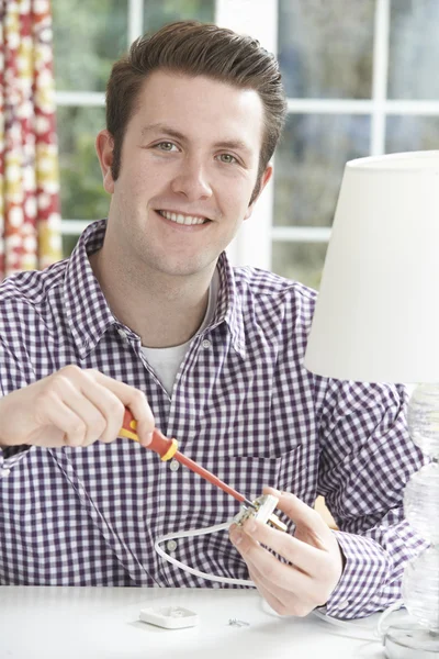 Man Wiring Electrical Plug On Lamp At Home — Stock Photo, Image