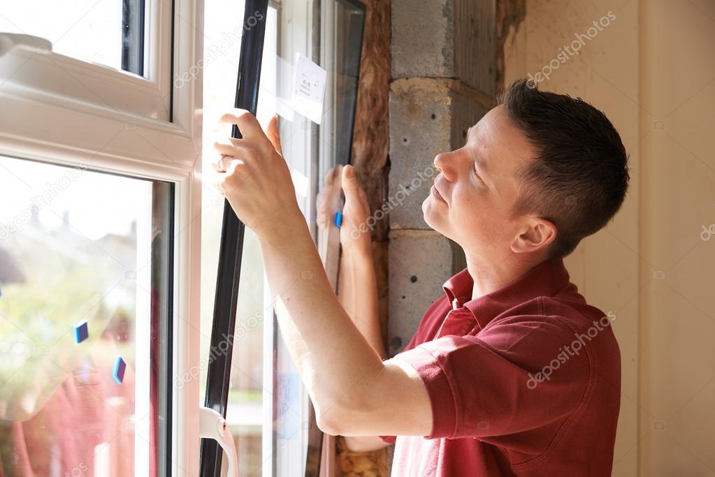 Construction Worker Installing New Windows In House