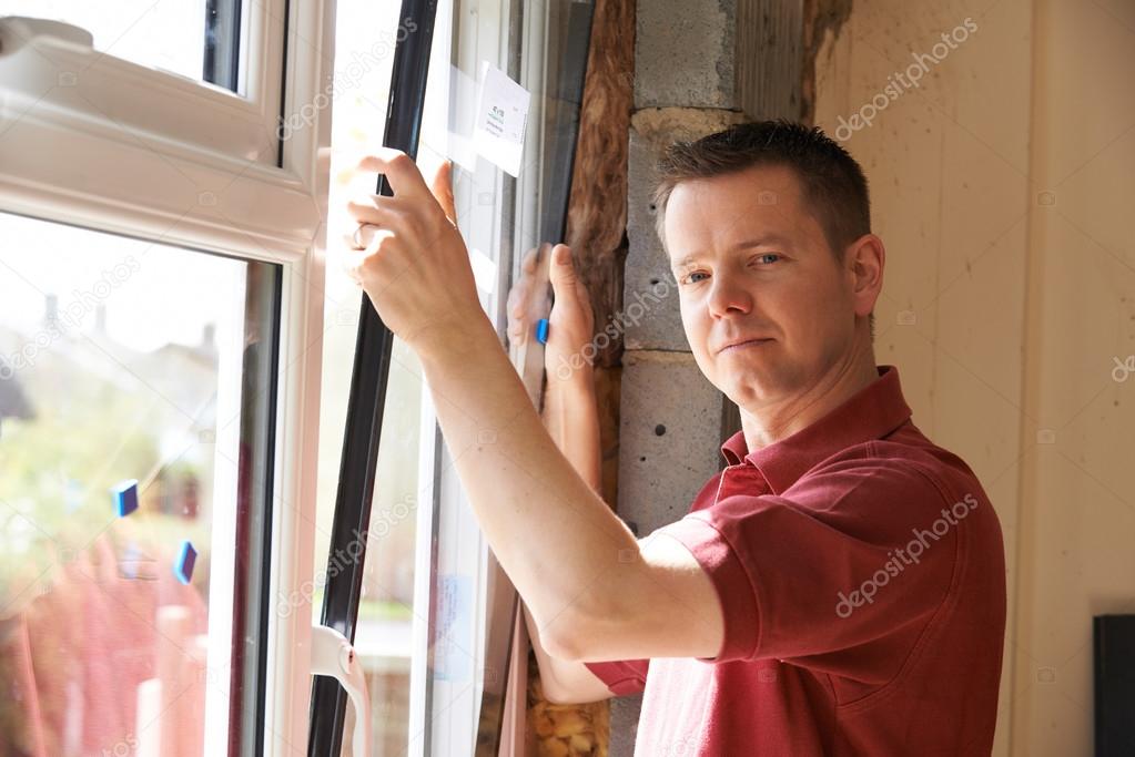 Construction Worker Installing New Windows In House