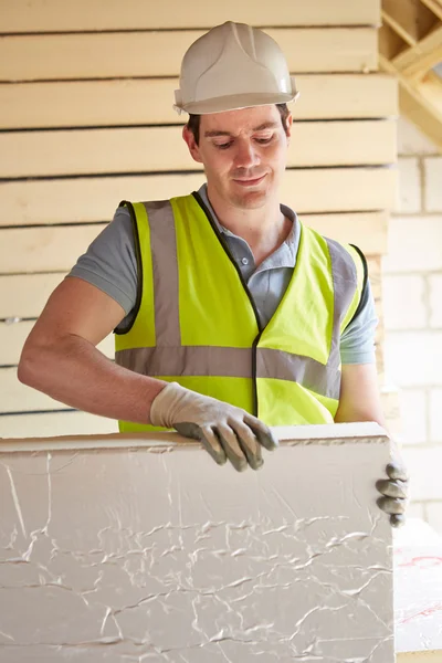 Builder Fitting Insulation Boards Into Roof Of New Home — Stock Photo, Image