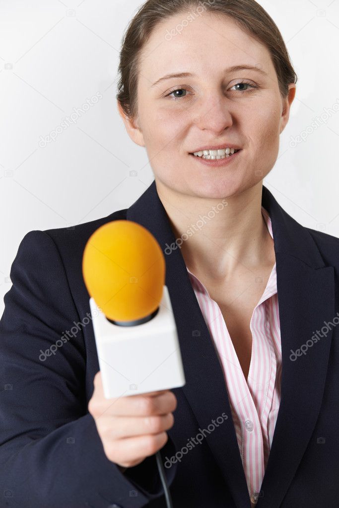 Studio Portrait Of Female Journalist With Microphone