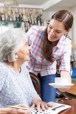 Teenage Grandmother Bringing Grandmother Hot Drink