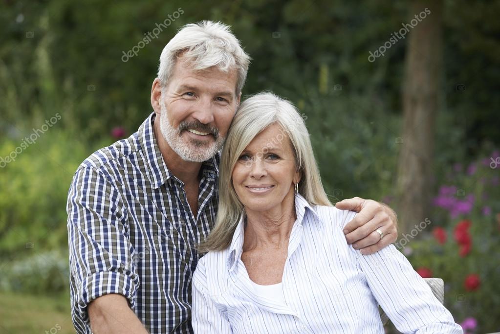 Portrait Of Mature Couple Relaxing In Garden Together