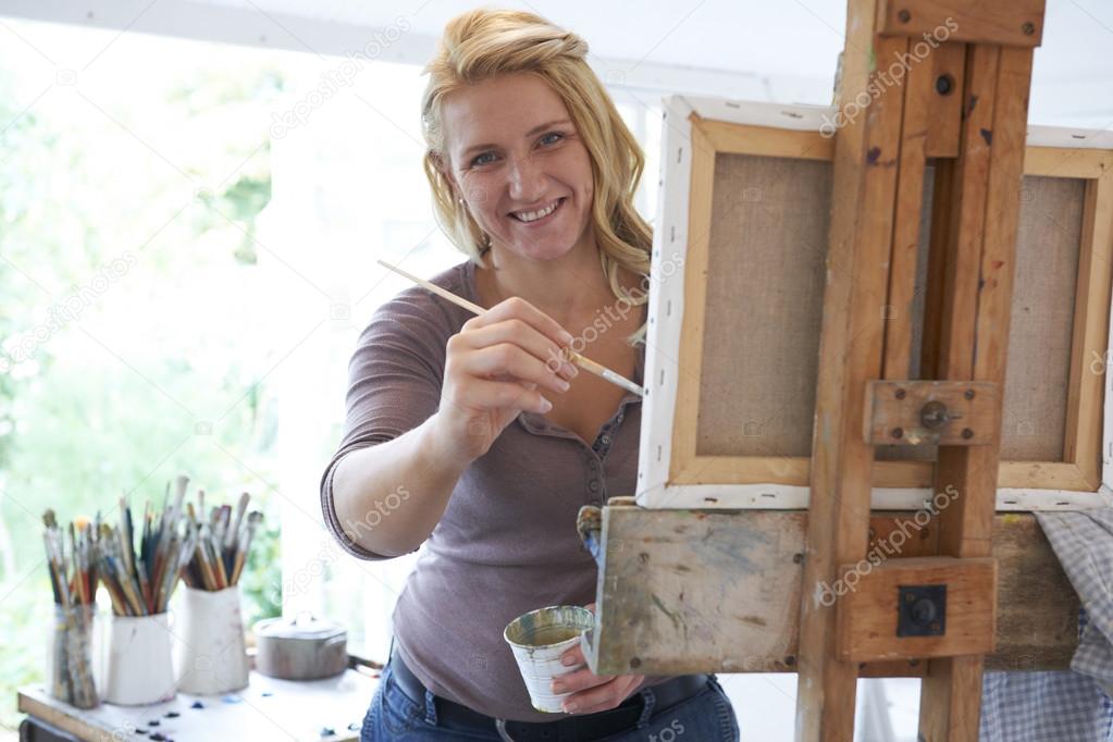 Portrait Of Female Artist Painting In Studio