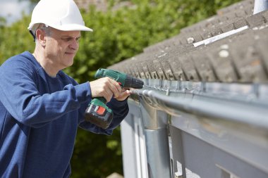Workman Replacing Guttering On Exterior Of House clipart