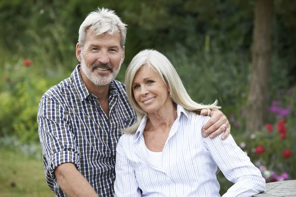 Retrato de pareja madura relajándose en el jardín juntos — Foto de Stock