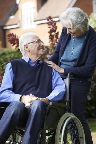 Senior Man In Wheelchair Being Pushed By Wife — Stock Photo, Image