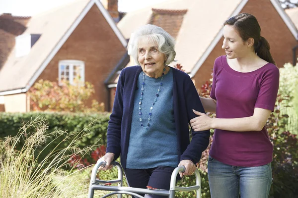 Daughter Helping Senior Mother To Use Walking Frame — Stock Photo, Image