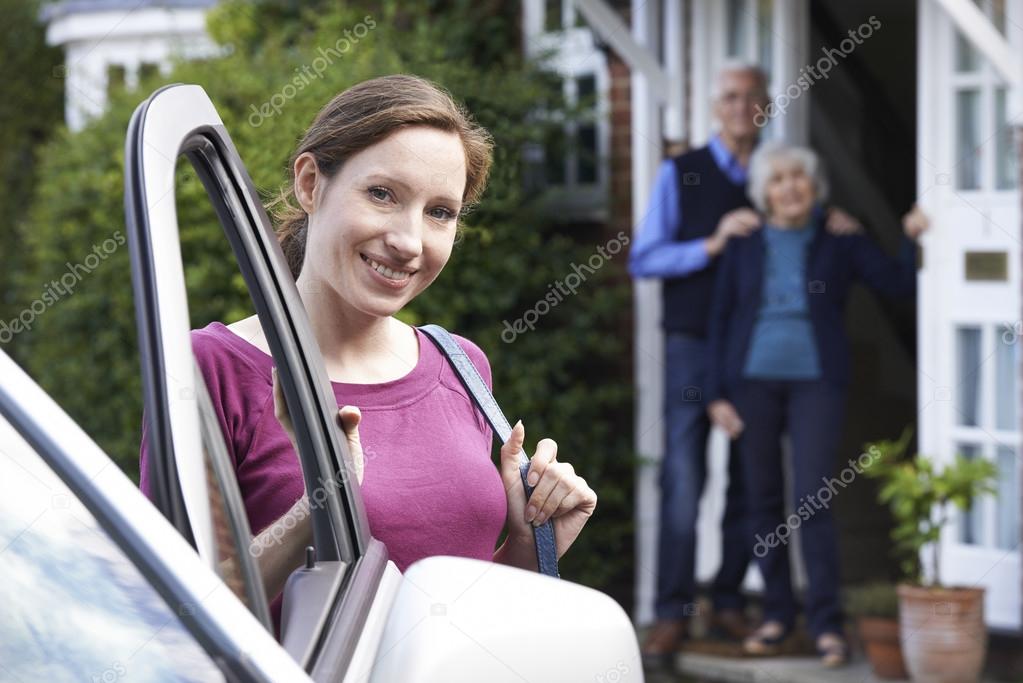 Adult Daughter Visiting Senior Parents At Home