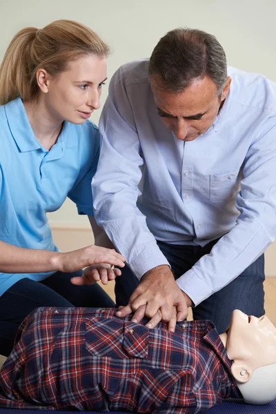 Donna che dimostra RCP sul manichino di formazione nella classe di primo soccorso — Foto Stock