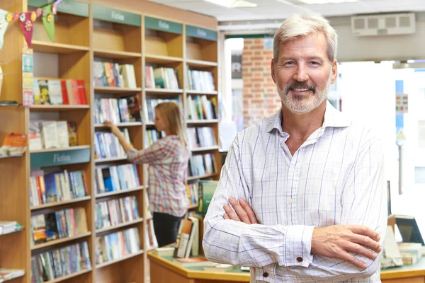 Portrait Of Male Bookstore Owner With Customer In Background — Stock Photo, Image