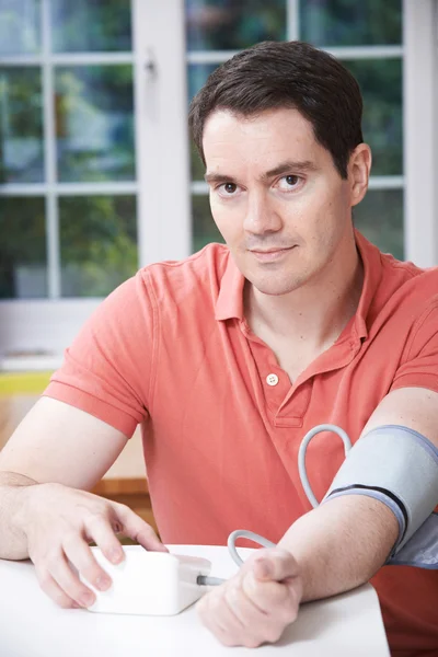 Man Measuring Blood Pressure At Home — Stock Photo, Image