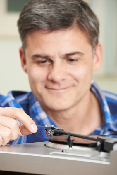 Mature Man Putting Vinyl Record On Player — Stock Photo, Image