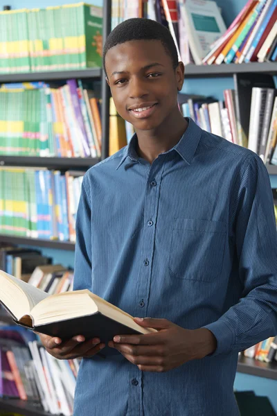 Estudiante adolescente masculino estudiando en la biblioteca — Foto de Stock