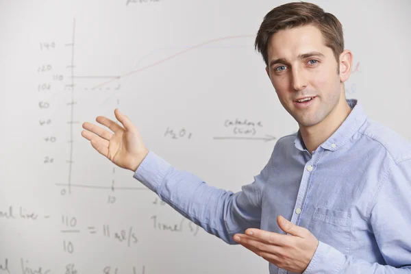 Teacher Standing In Front Of Whiteboard Stock Picture